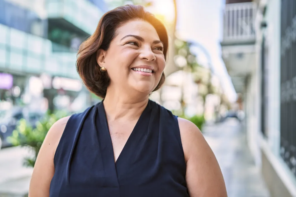Smiling woman in a navy top on a city street
