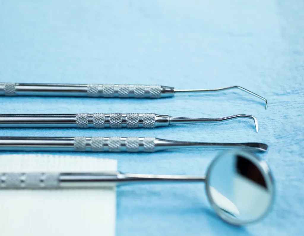 Dental instruments laid out on a blue cloth