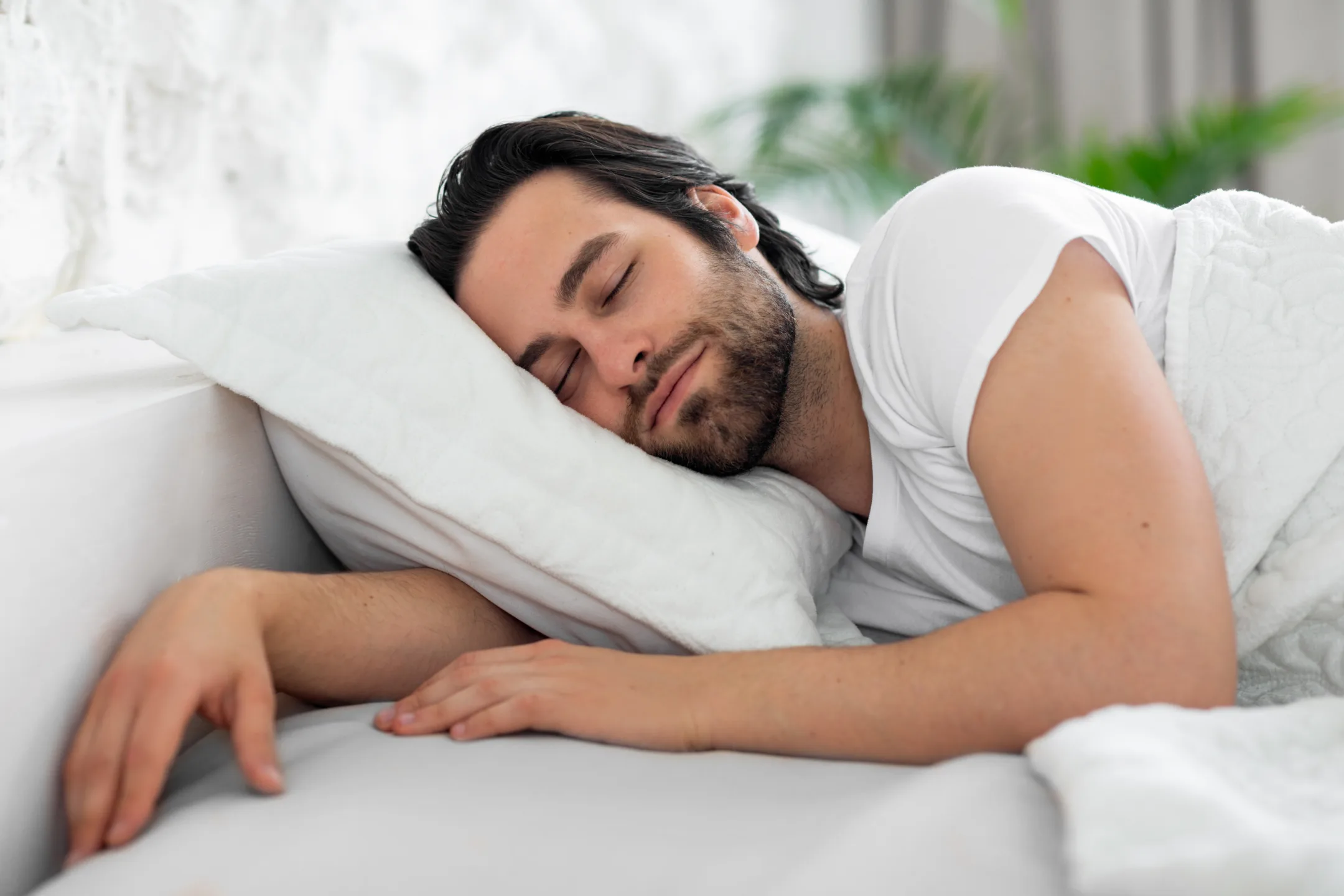 Man sleeping on his side in bed